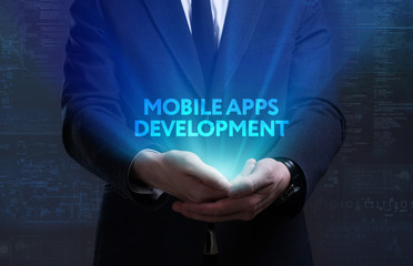 Business, Technology, Internet and network concept. Young businessman working on a virtual screen of the future and sees the inscription: Mobile apps development