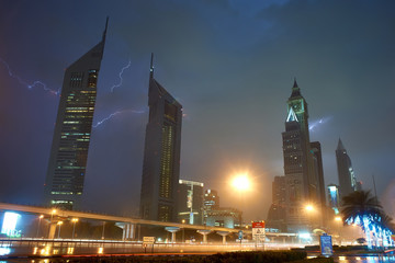 emirates tower at night it rains and beats lightning.
