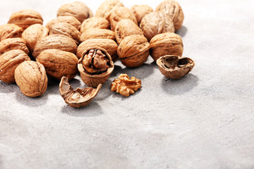 Walnut kernels and whole walnuts on rustic old table