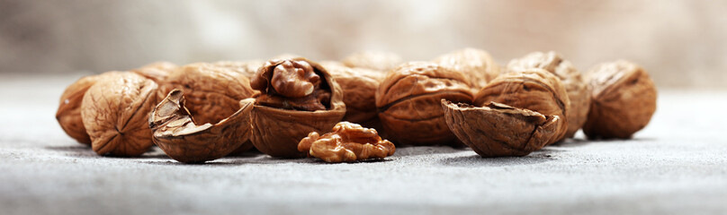Walnut kernels and whole walnuts on rustic old table