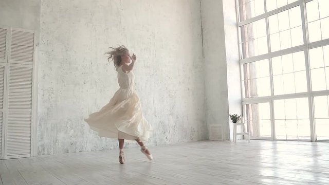 ballerina in white light dress and Pointe shoes. conecpt of lightness and youth