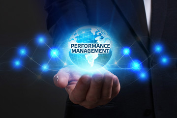 Business, Technology, Internet and network concept. Young businessman working on a virtual screen of the future and sees the inscription: Performance management