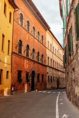 Fototapeta na wymiar Journey to Italy. The narrow streets of Siena with colored houses