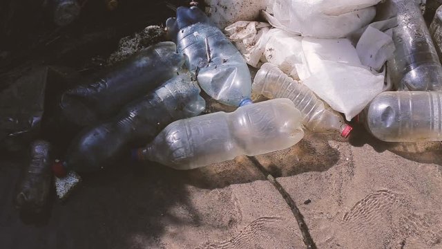 Heavy polluted water stream with domestic garbage