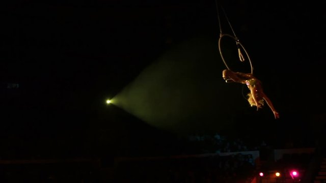 Young girl performs the acrobatic elements in the air ring