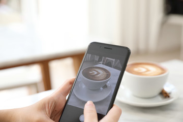 Close up of women hands take a picture coffee in coffee shop