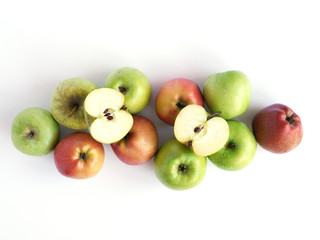 Green and red apples isolated on white background, top view, flat layout.