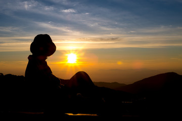 silhouette person feel with background sunrise at top moutain