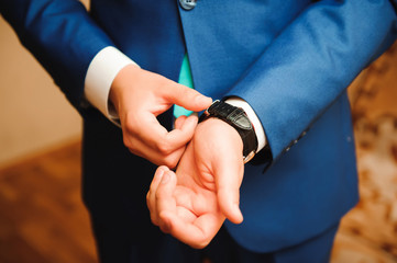 elegant businessman dressed clock before meeting with partners