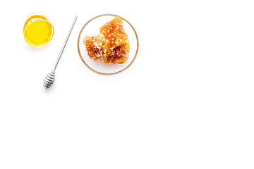 Apiary products. Honey in bowl and honeycomb on white background top view copy space