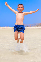 boy jumping on the beach