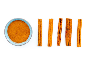Cinnamon seasoning. Sticks and powder on white background top view
