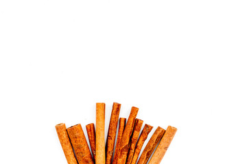 Cinnamon sticks on white background top view copy space. Condiment for mulled wine