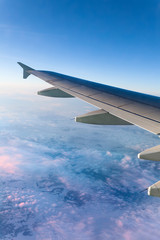 Fototapeta premium Airplane Wing above the Clouds