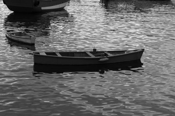 photograph black and white small wooden fishing boats without anyone stopping in Urca lake city of rio de janeiro 2018
