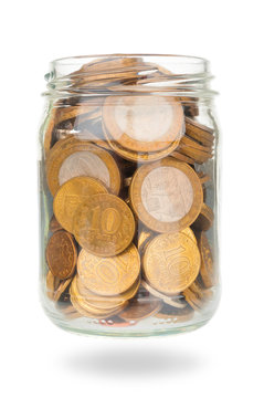 Russian ruble coins in glass jar on white background