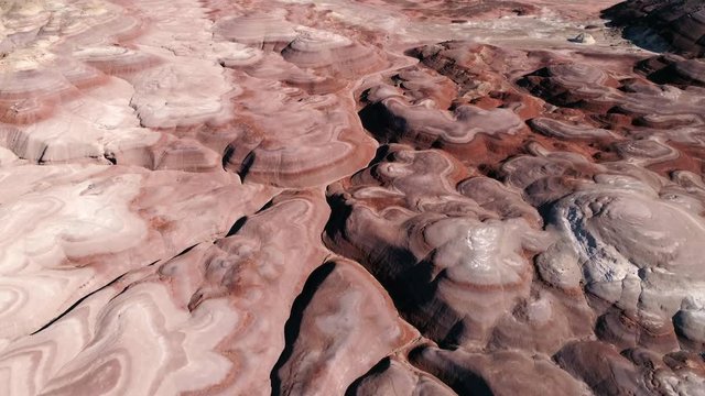 View of mars desert canyons and swirls of color in Utah from aerial view.