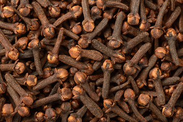 food background of dried cloves, top view