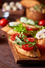 Breakfast sandwich with homemade paste, vegetables and fresh greens, shallow depth of field