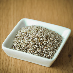 Organic Dry Chia Seeds in small white plate