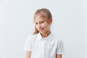 Little girl with cunning facial expressions on a white background