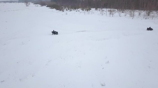 View from the height of ATVs riding through the snowy landscape in winter