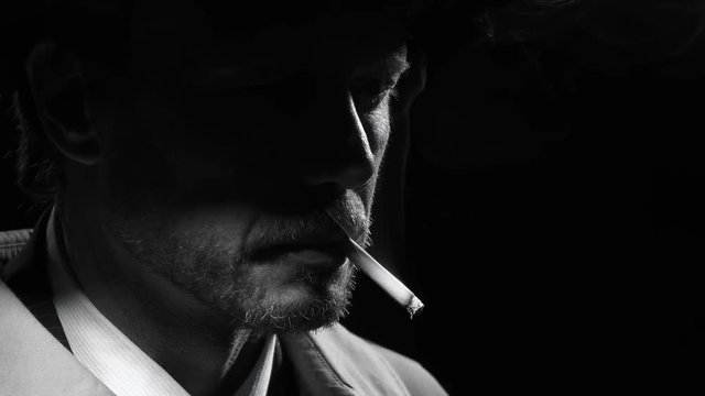 Portrait of a retro noir detective smoking a cigarette