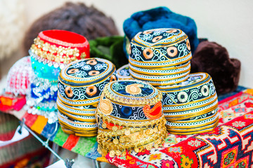 Fototapeta na wymiar Azerbaijan old style hats on a local market. Oriental headdress on Festive fair on Novruz holiday