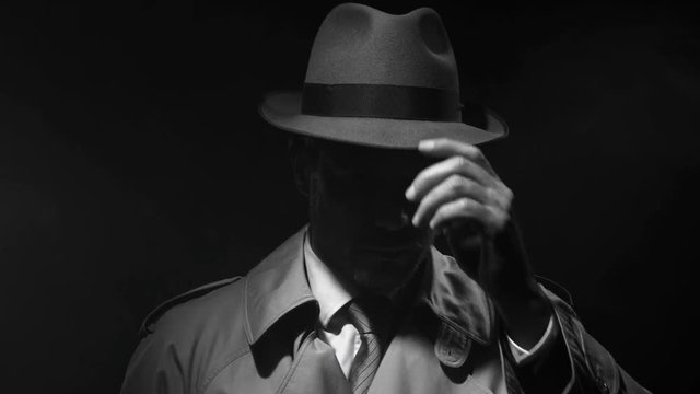 Noir film investigator standing in the dark