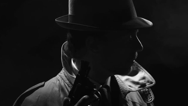 Retro detective spy holding a revolver