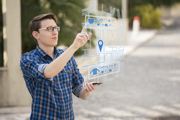 Augmented reality in marketing. Man traveler with phone. Navigation on the projection of the display