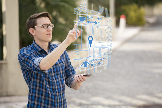 Augmented reality in marketing. Man traveler with phone. Navigation on the projection of the display
