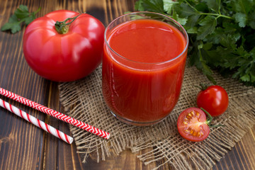 Tomato juice  on the rustic wooden background
