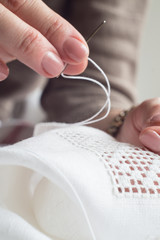 Woman's hands embroider ornaments