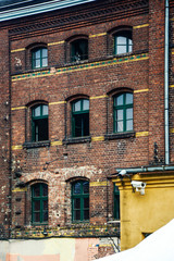 Fototapeta premium old tenement house with windows and brick wall