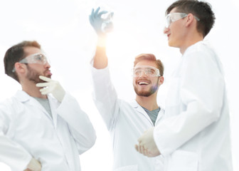 scientists studying the liquid in the beaker.