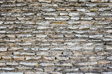 Ancient gray brick wall. Antique stone texture.