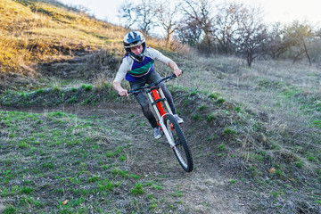 Enduro Cyclist Riding the Mountain Bike on the Rocky Trail.