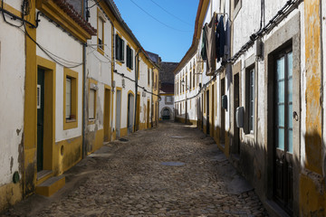 Fototapeta na wymiar View of a narrow cobblestone street in the village of Nisa, Alentejo, Portugal; Concept for travel in Portugal and discover Portugal