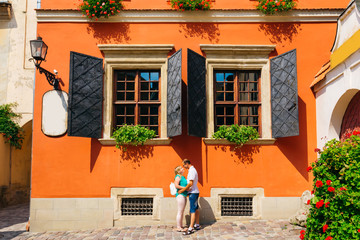 Fototapeta na wymiar a mature couple standing face to face against a beautiful building with an orangery facade and beautiful windows