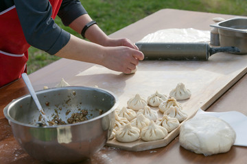 Khinkali cooking. Georgian trafitional local dish. Women cooks meat dumplings for her family.