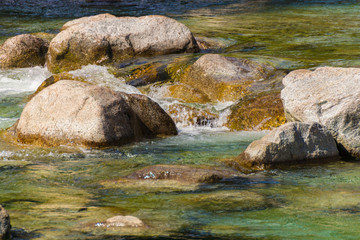 Flowing water of river Sarca in Val Genova next to the Cascate Nardis seen on a sunny spring day, Trentino, Italy, Europe