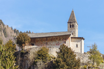 Fototapeta na wymiar Ancient alpine mountain church of Santo Stefano (St. Stephen) seen on a sunny spring day in Carisolo, Val Rendena, Trentino, Italia