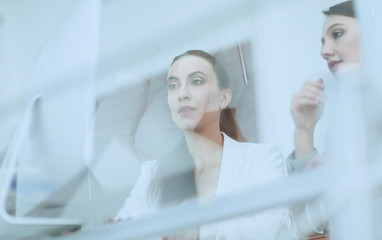 behind the glass.business team sitting at Desk