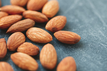 Macro photography of almond nuts over grey background. The concept of healthy and organic food.