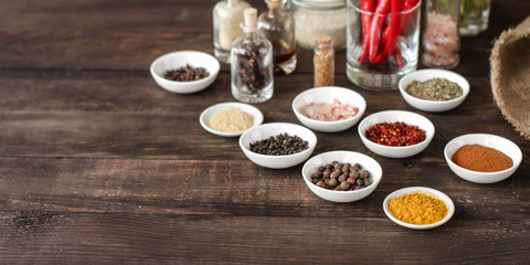 Spices and herbs. Variety of spices and herbs on a dark wooden surface