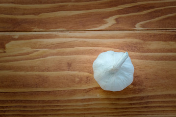 Close-up view of raw healthy organic garlic cloves on rustic wooden table, selective Focus