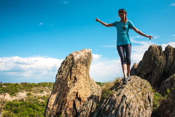 woman climbs to the top of the mountain