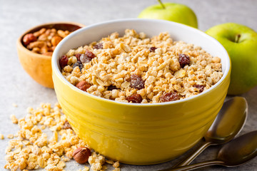 Granola and muesli in bowl on gray stone background