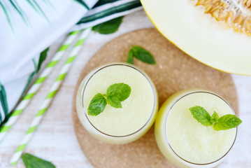 Cold fresh melon smoothies with mint in glass, summer drink beverage, healthy food concept, freshness, exotic fruits